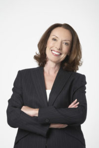 Portrait of a happy businesswoman with hands folded on white background